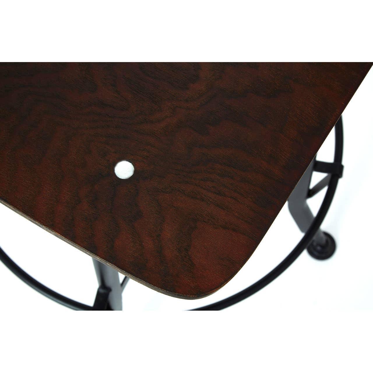 Close-up of dark wood bar stool seat with metal base and circular footrest