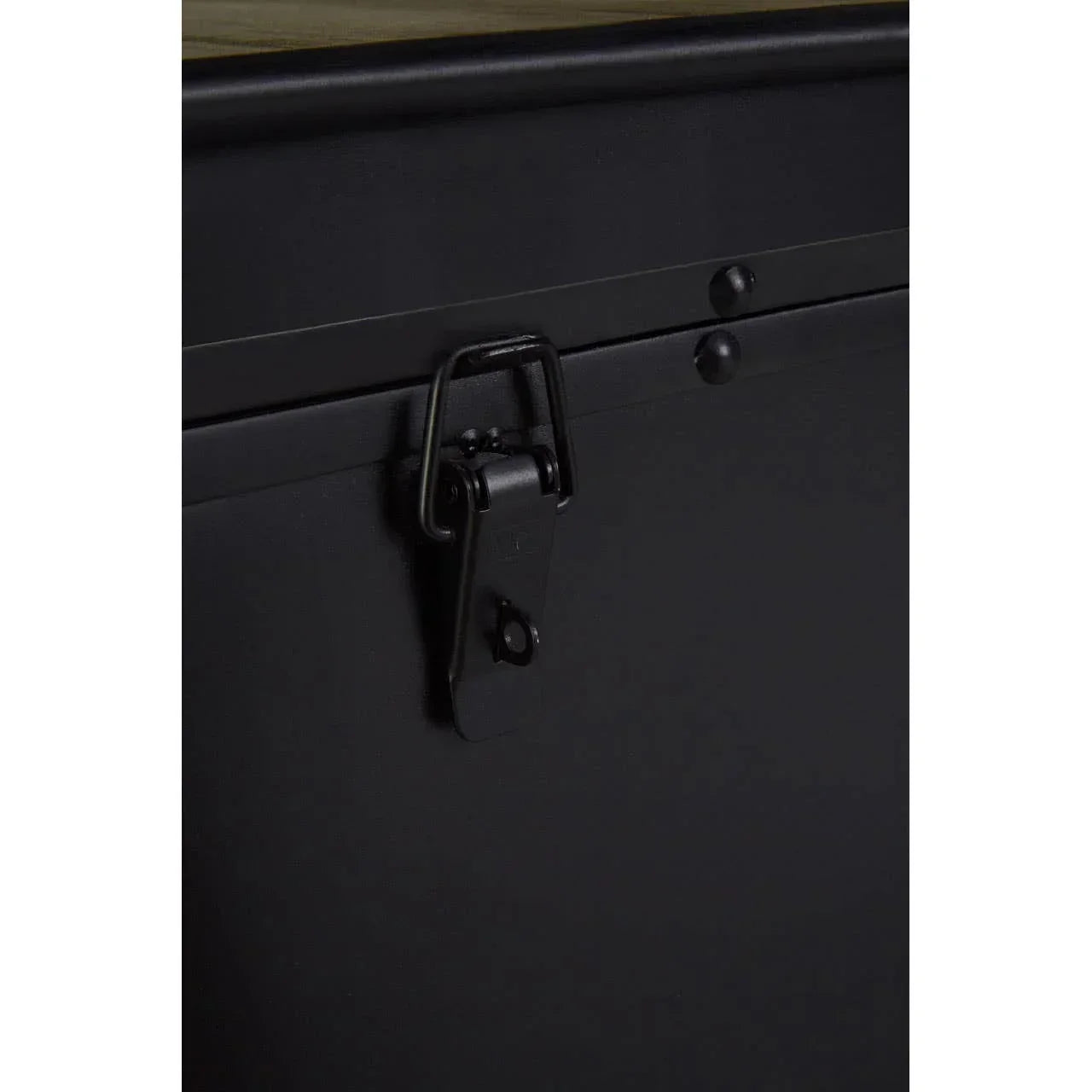 Black metal storage trunk latch with rivet detail and wooden top corner