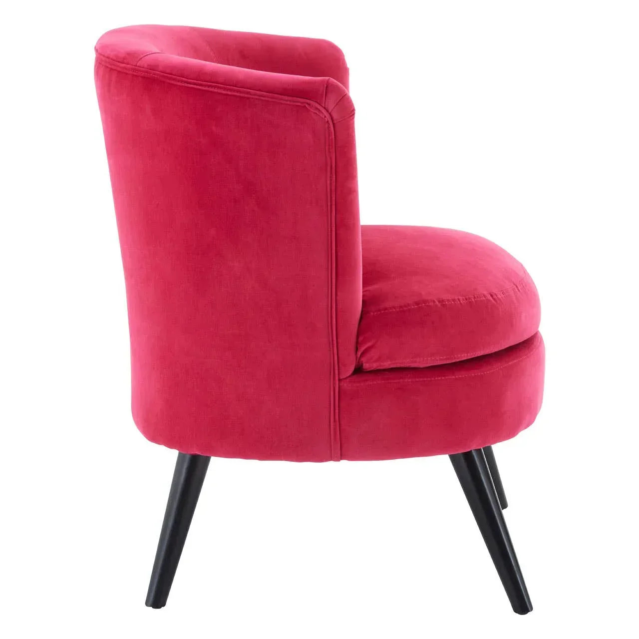 Side view pink velvet accent chair with curved back and black tapered legs