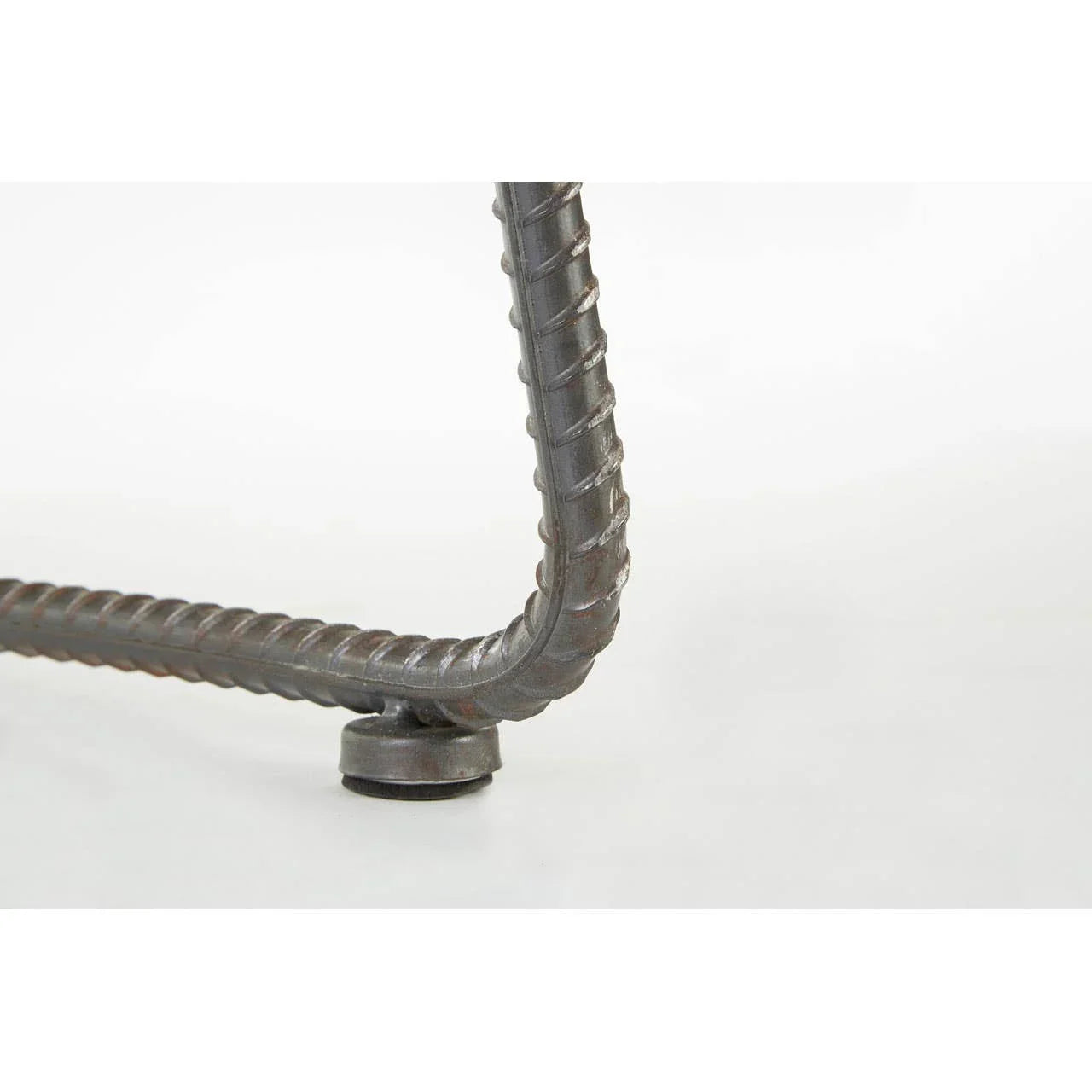 Close view of metal table leg with ribbed steel detail and adjustable foot