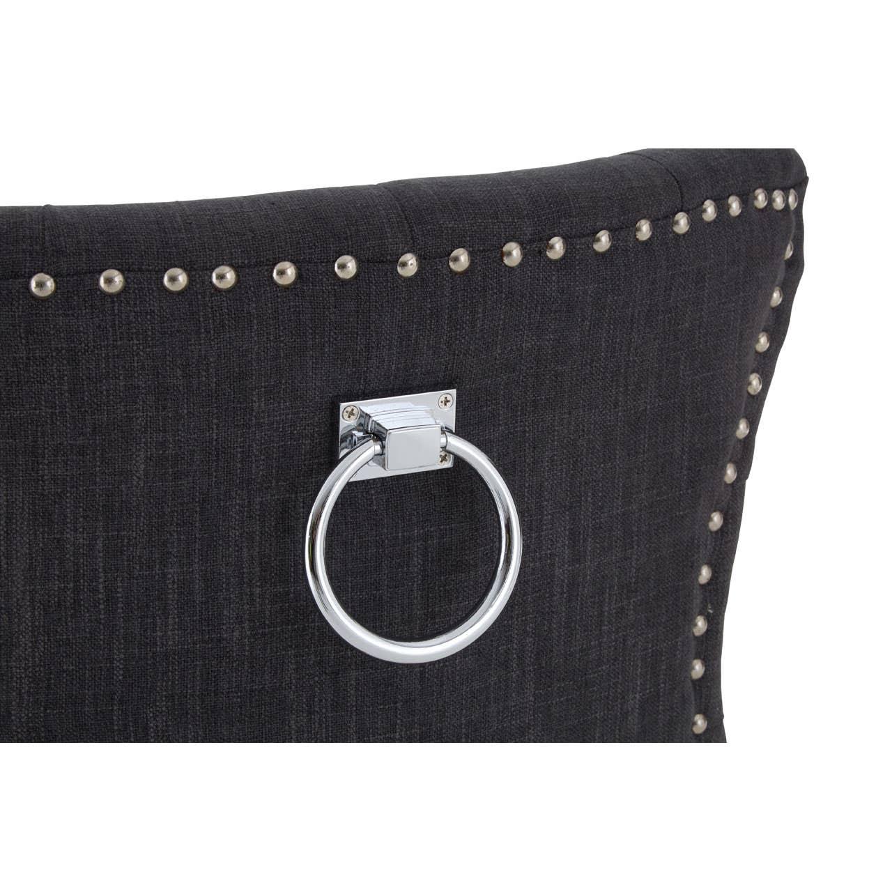 Dark fabric dining chair back with metal ring handle and silver stud detailing