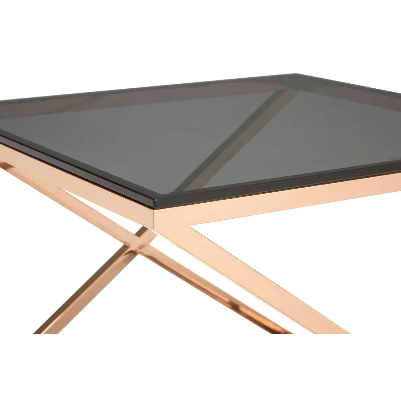 Glass top side table with rose gold metal frame and crossed legs, corner angle view