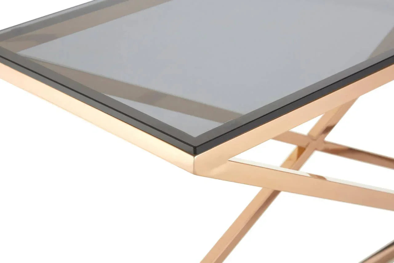 Glass top coffee table with gold metal frame, close-up corner view