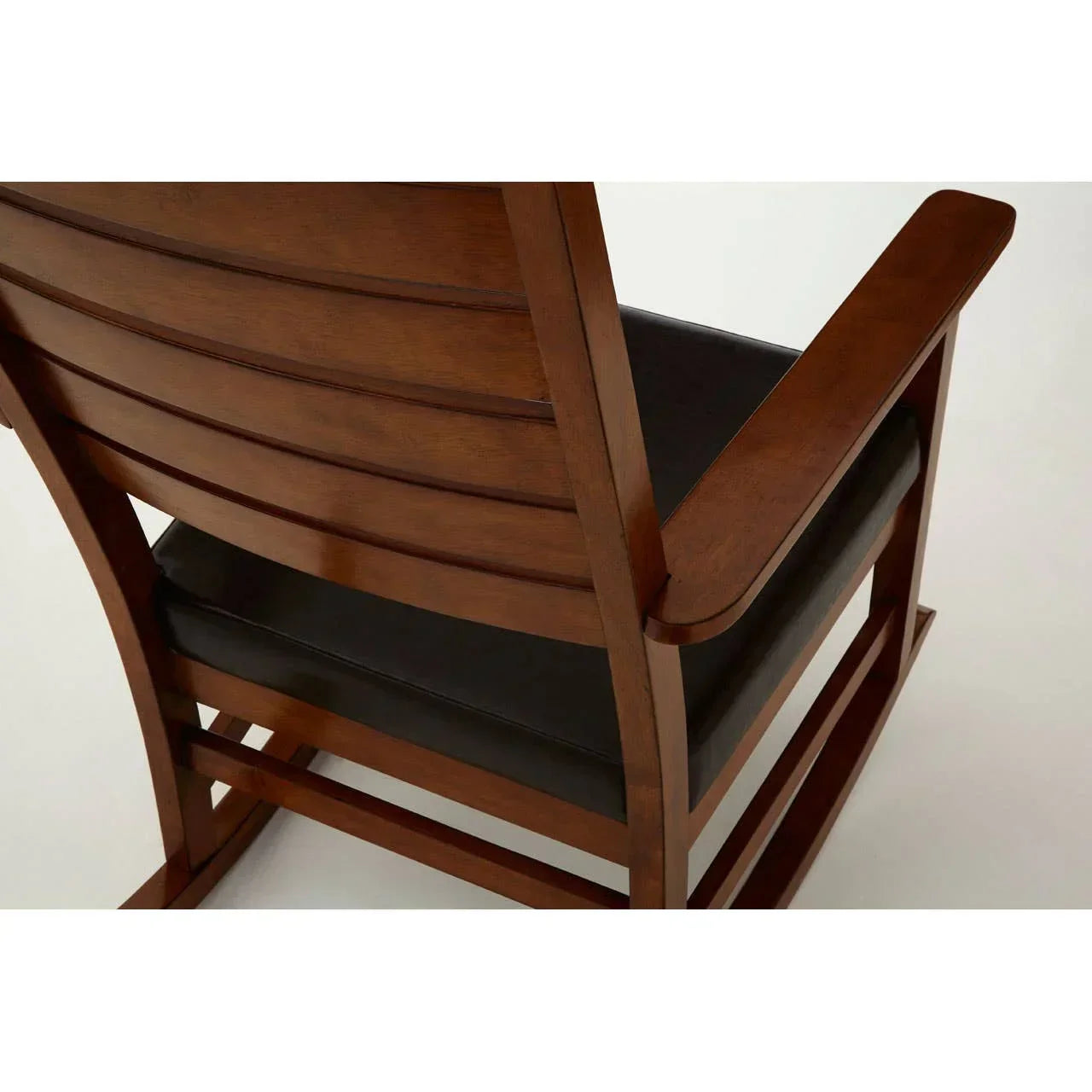 Wooden rocking chair with slatted back and black cushioned seat, rear angle view