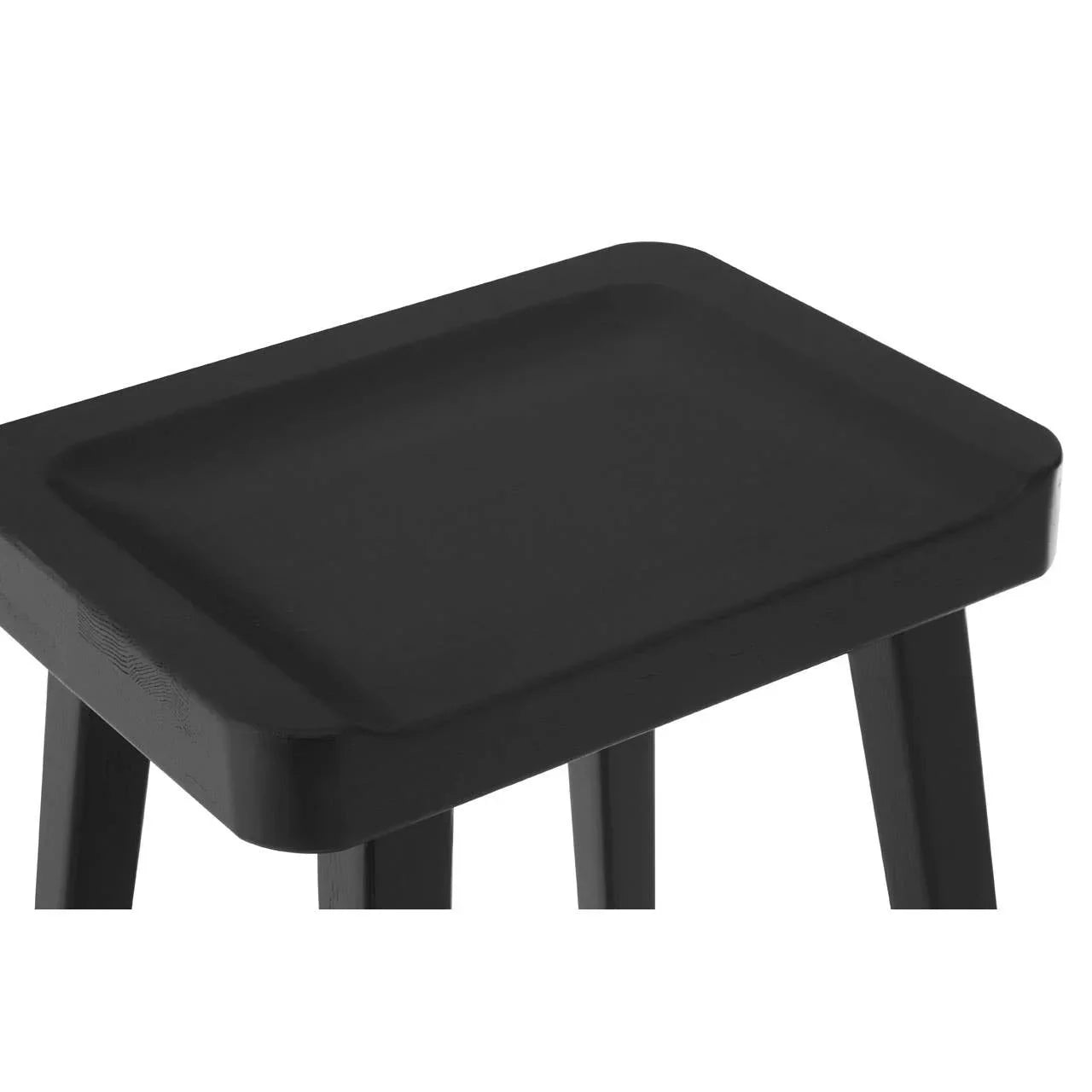 Black wooden stool with rectangular seat and four legs, close-up angle