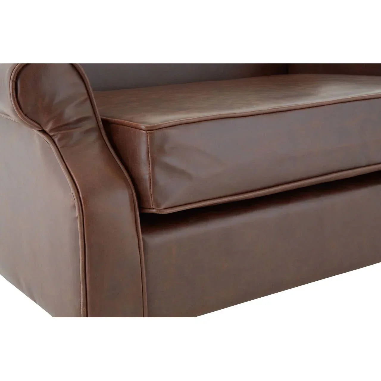 Brown leather sofa arm and seat cushion close-up