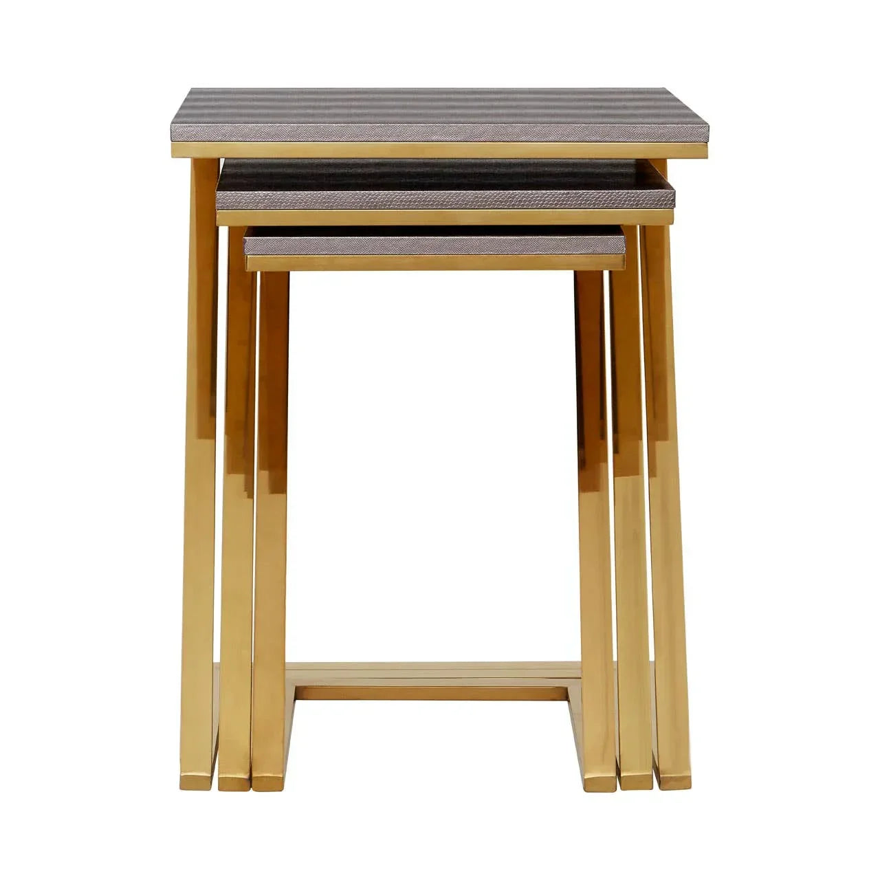 Gold metal nesting tables with textured grey tops, arranged in a stacked set