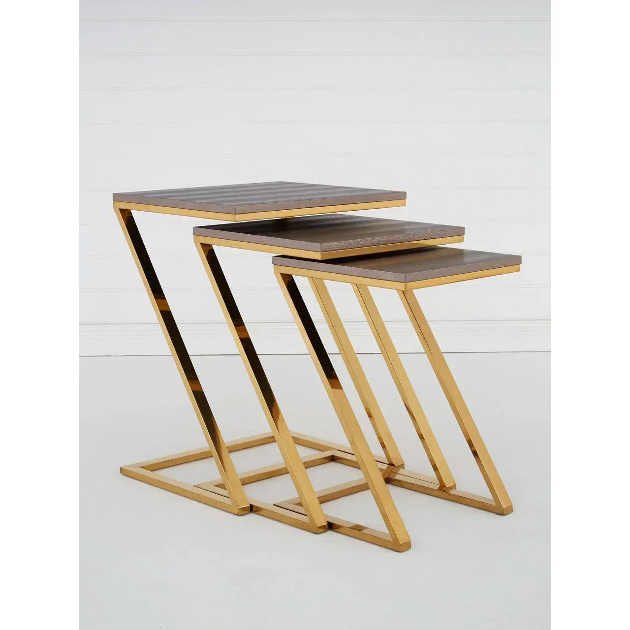 Gold metal frame nesting tables with wood tops, set of three, side view