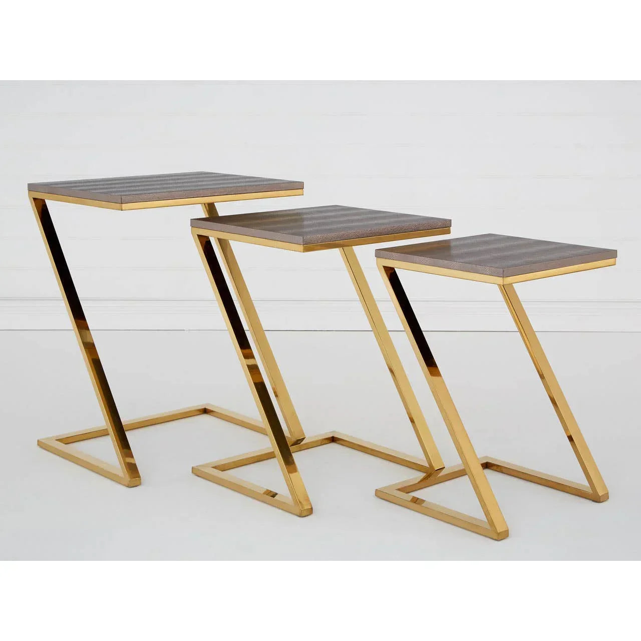 Set of three gold metal nesting tables with wood tops, modern design, side view