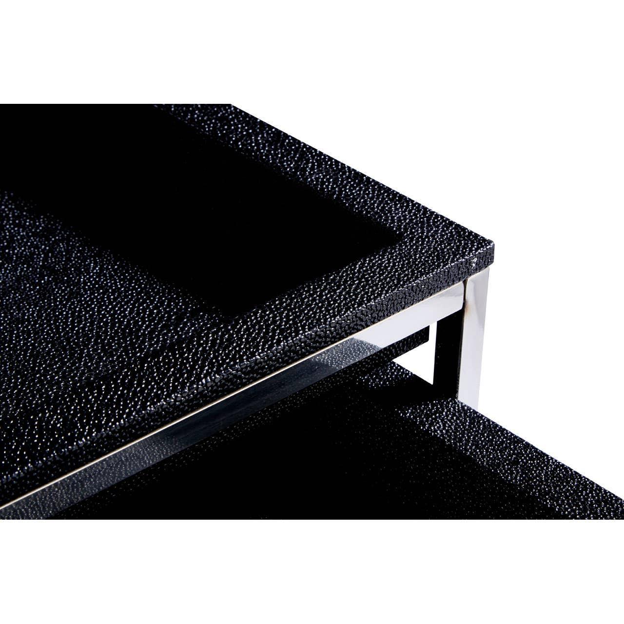 Closeup of black textured coffee table surface with chrome metal frame