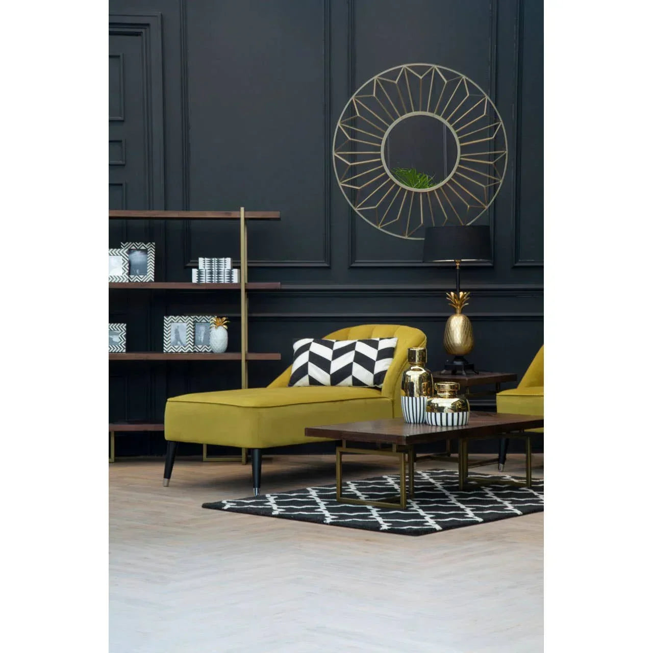 Mustard yellow chaise lounge with geometric cushion beside modern coffee table and bookshelf