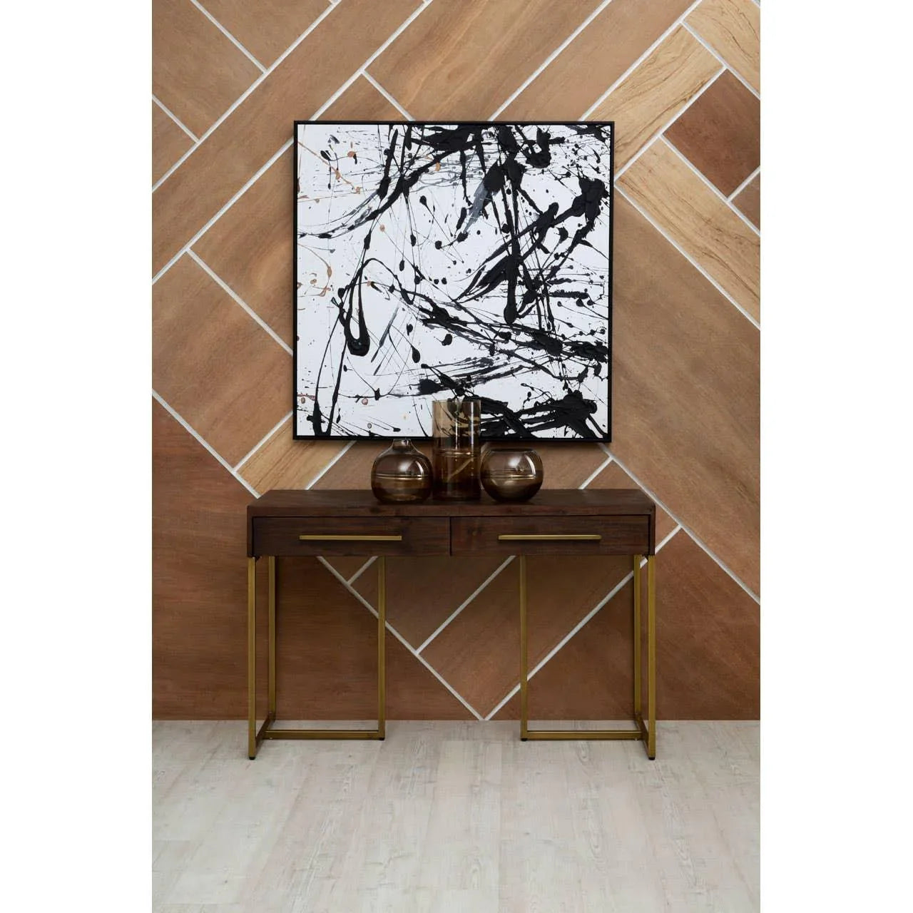 Dark wood console table with gold legs and vases, placed against modern wood panel wall