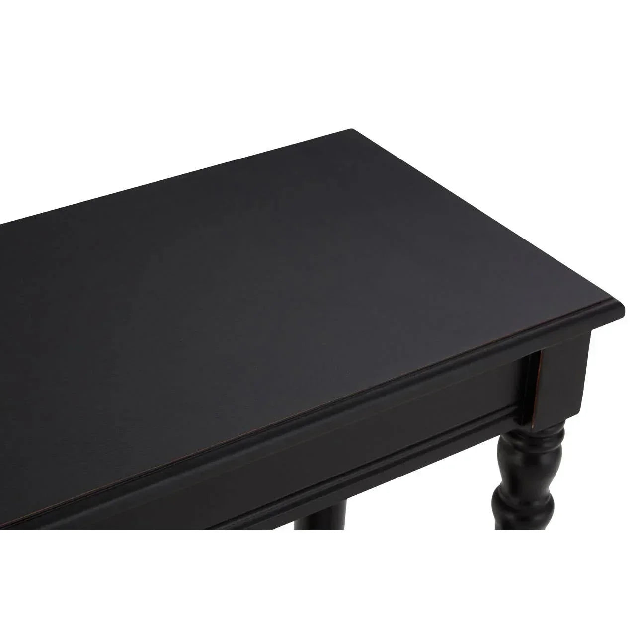 Black wooden console table corner with spindle leg and smooth top surface