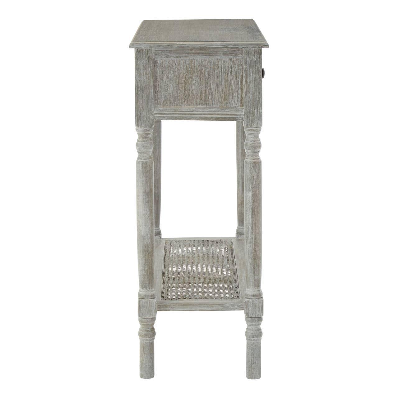 Grey wooden side table with carved legs and lower rattan shelf, shown from the side