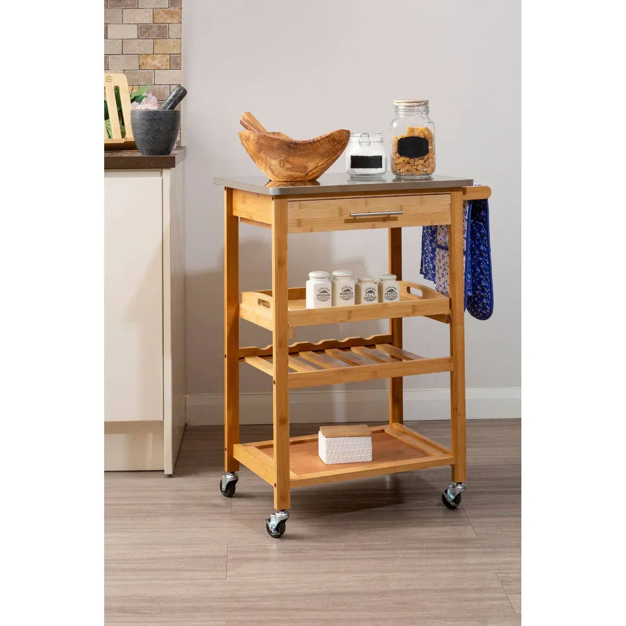 Wooden kitchen trolley with stainless steel top, storage shelves, and caster wheels