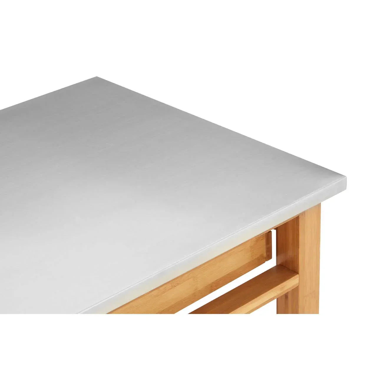 Corner view of dining table with stainless steel top and wooden legs
