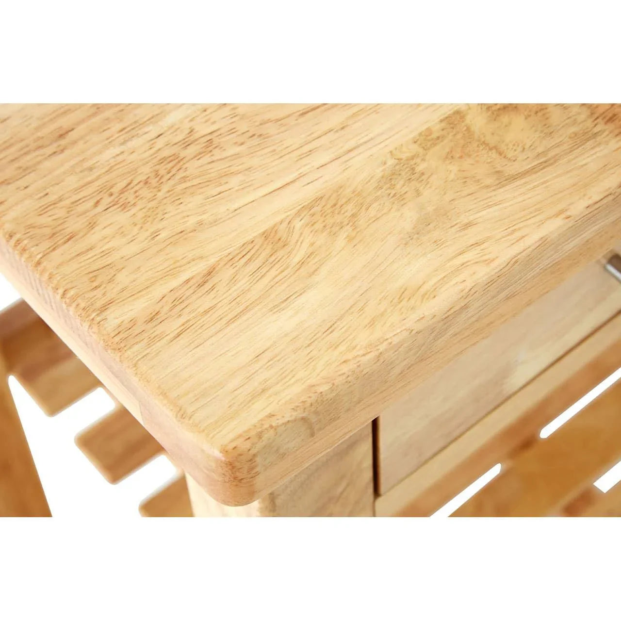 Close view of light wood dining table corner with smooth finish and visible wood grain