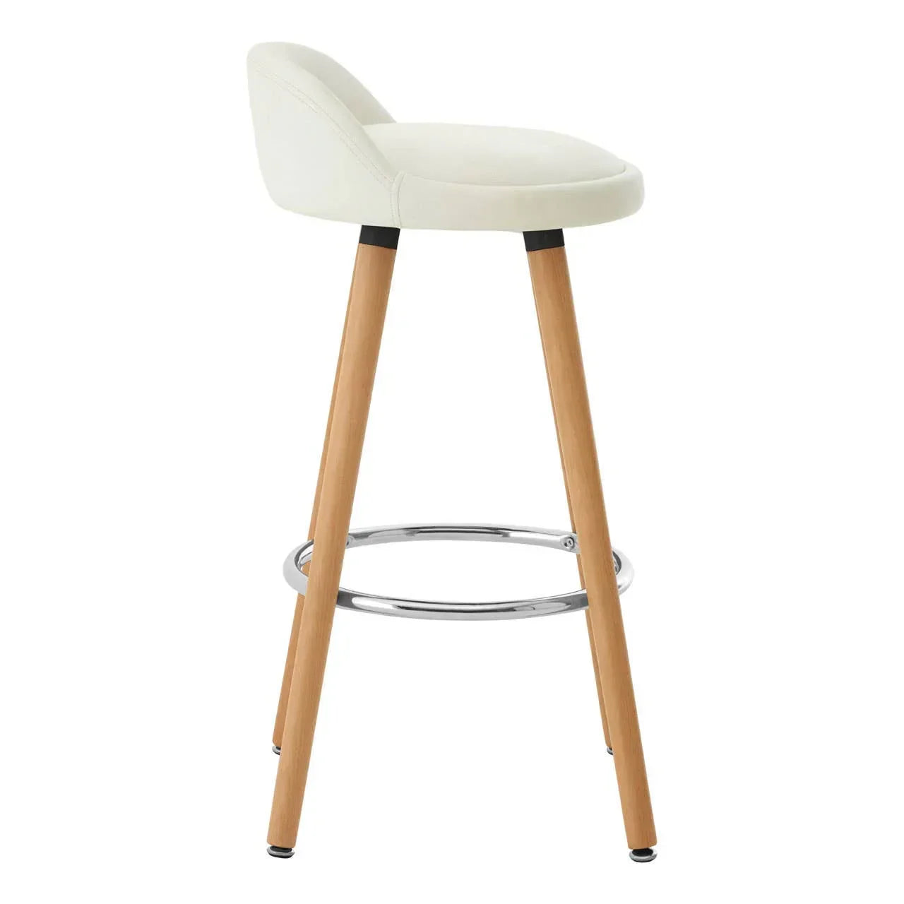 Cream bar stool with low backrest, wooden legs, and chrome footrest, side angle view
