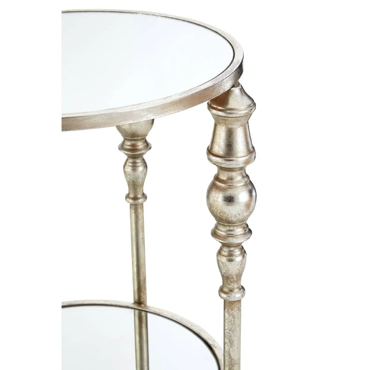 Round mirrored side table with metallic finish and turned legs, close-up view