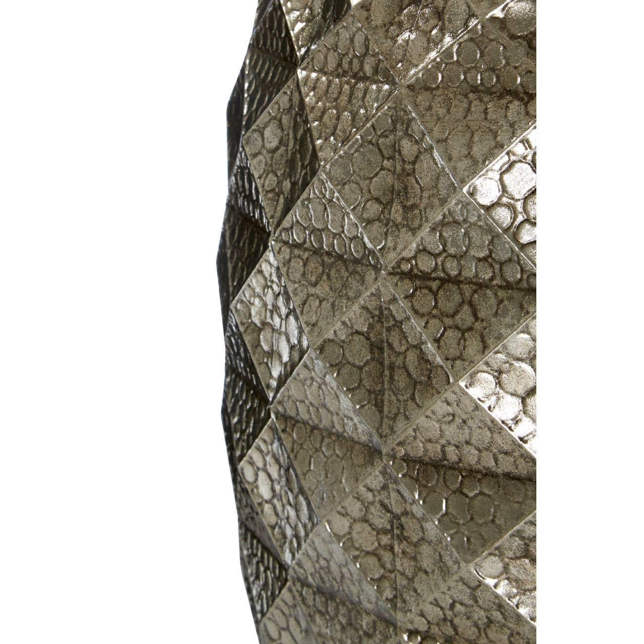 Close view of metallic vase with geometric textured diamond pattern