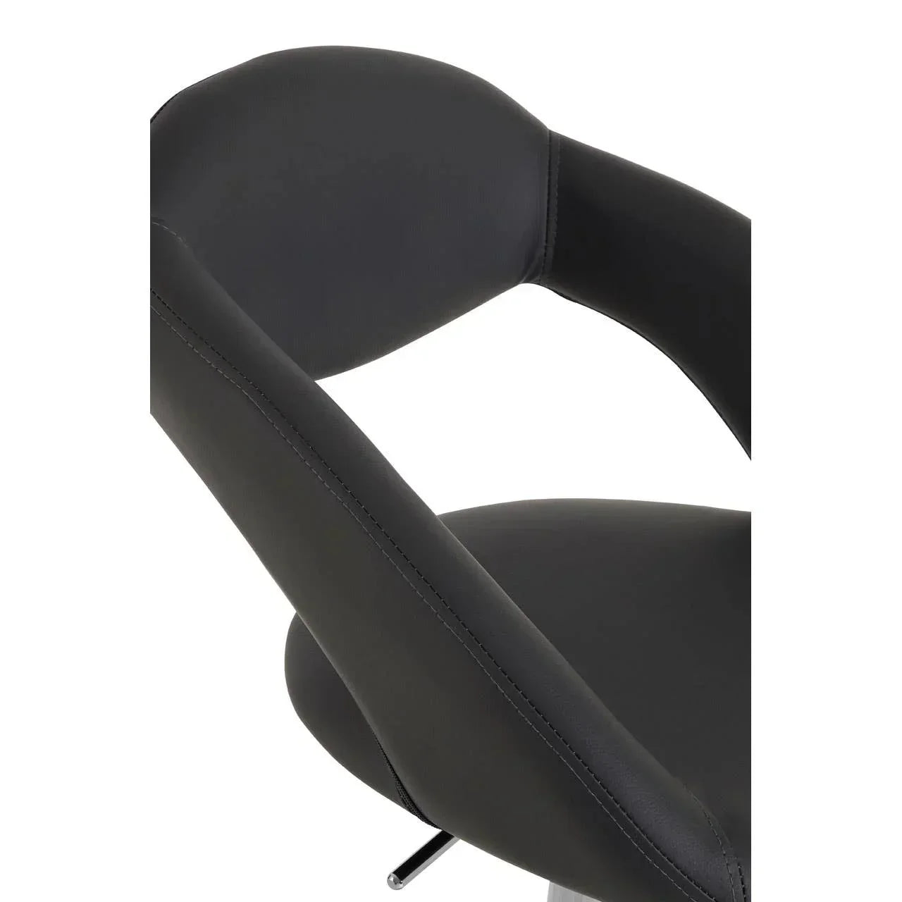 Close-up of black faux leather dining chair with curved backrest and padded seat