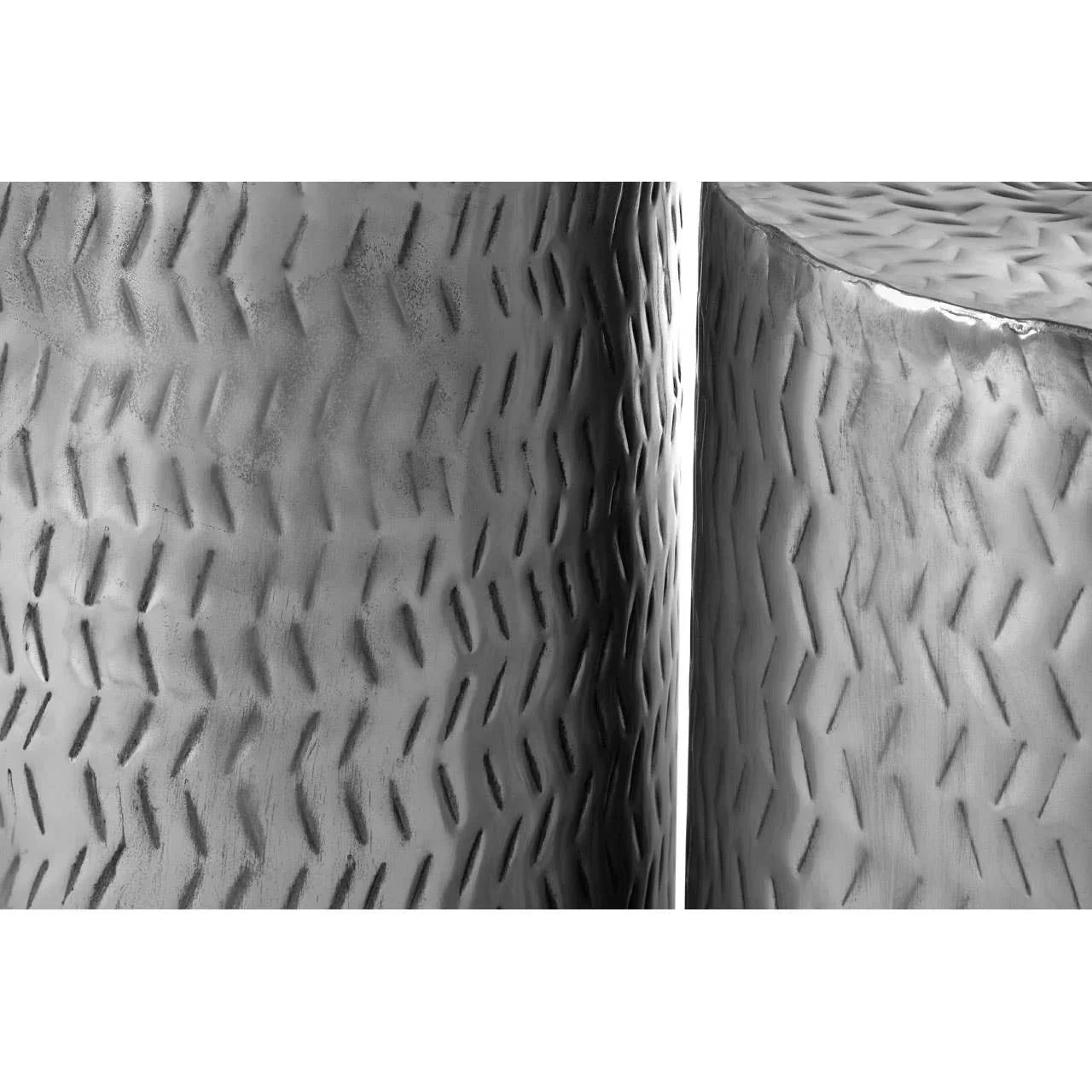 Close-up of silver hammered metal side table with textured surface detail