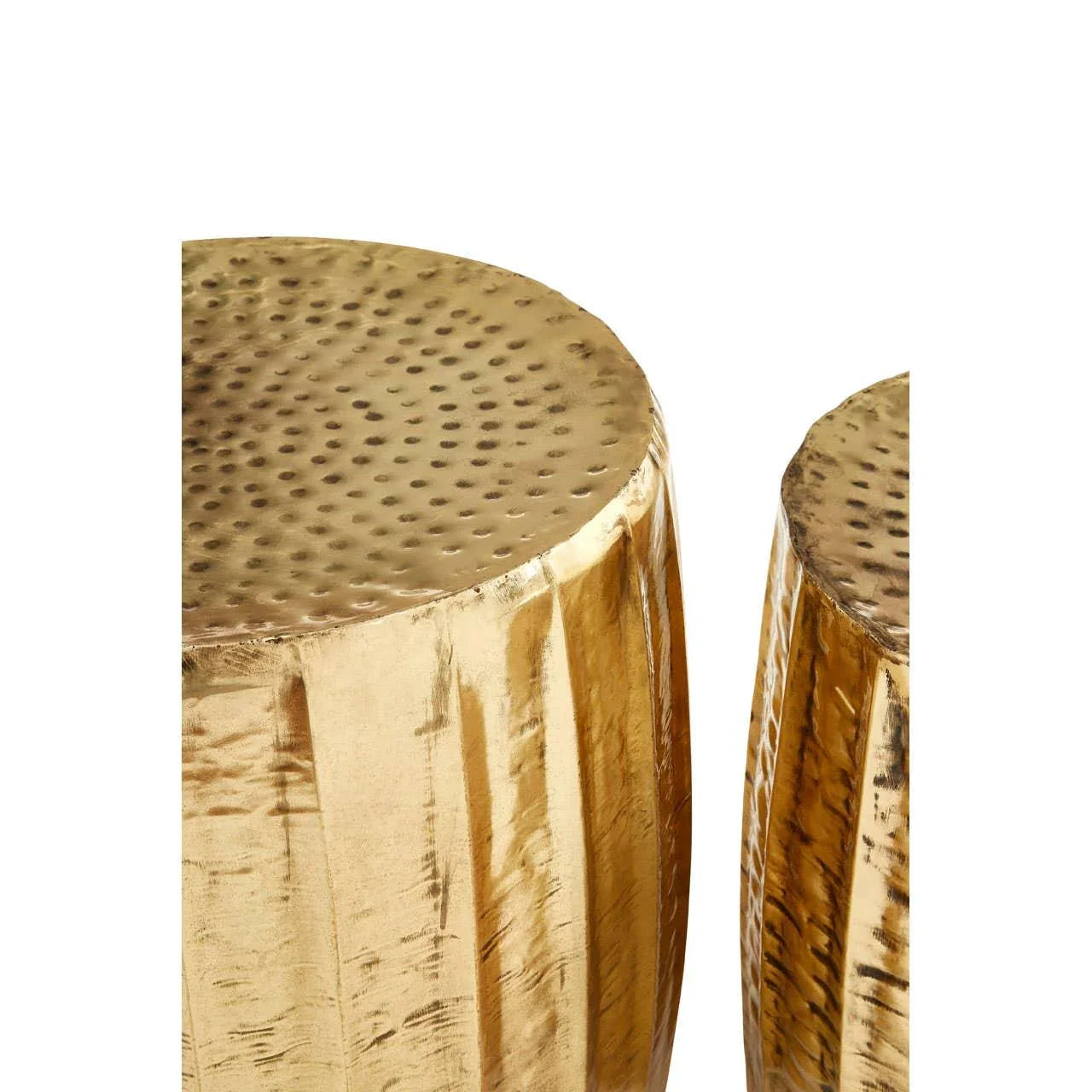 Gold hammered metal side tables with textured tops and vertical grooves, close-up view
