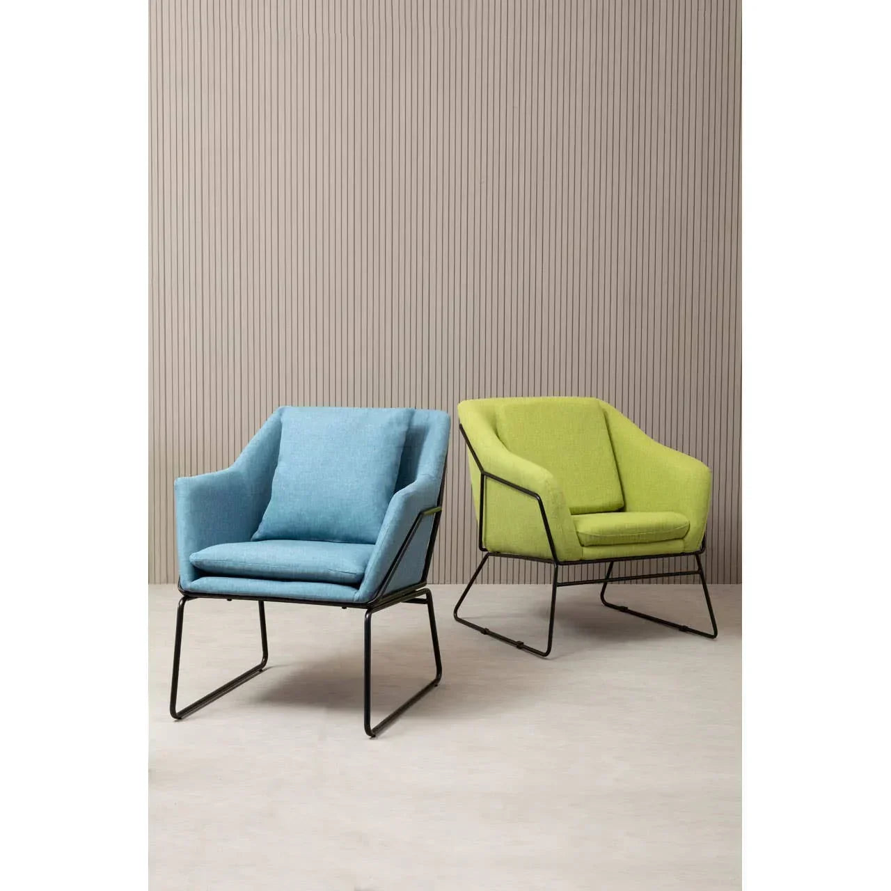 Blue and green fabric accent chairs with black metal frames on light flooring
