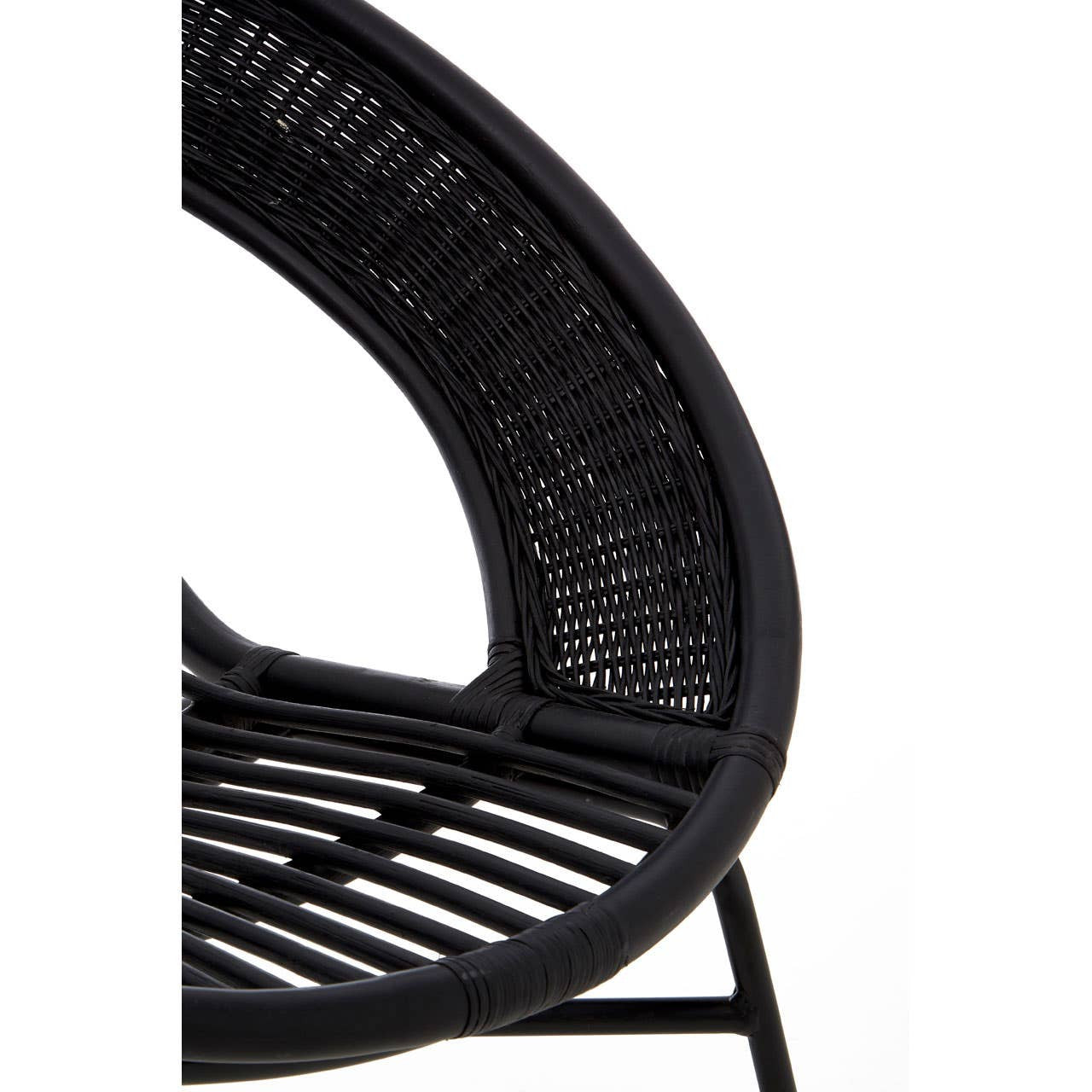 A close-up view of a black chair featuring a natural rattan seat and backrest, supported by a sleek black iron frame. The chair has a curved design with visible woven patterns in the rattan, showcasing its modern and stylish aesthetic