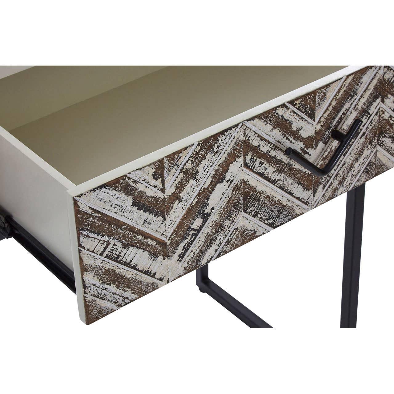 Wooden desk with chevron pattern drawer front and black metal handle, close up view