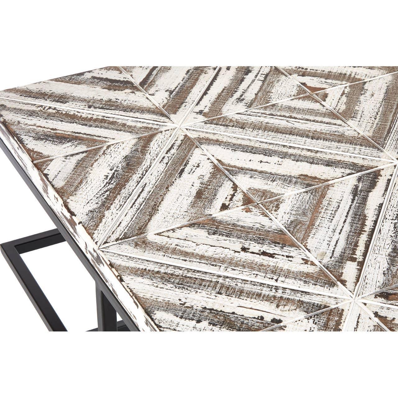 Distressed wood coffee table with geometric pattern and black metal legs, angled view