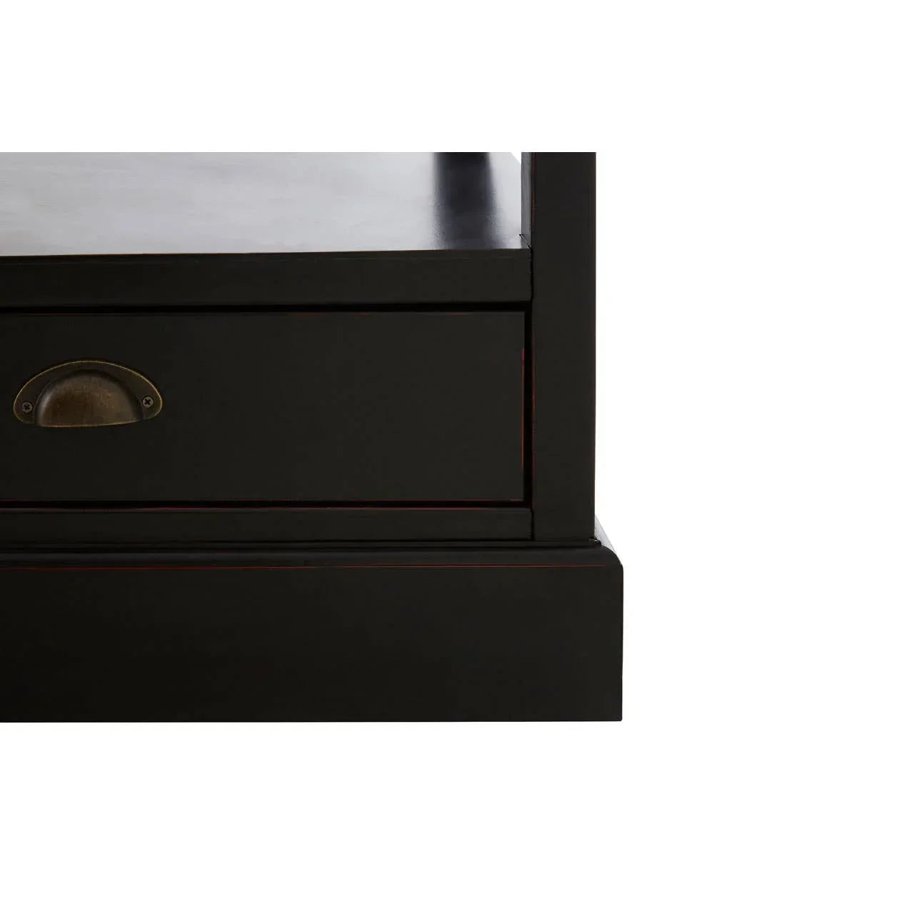 Close-up of black wood furniture drawer with brass cup handle and solid base