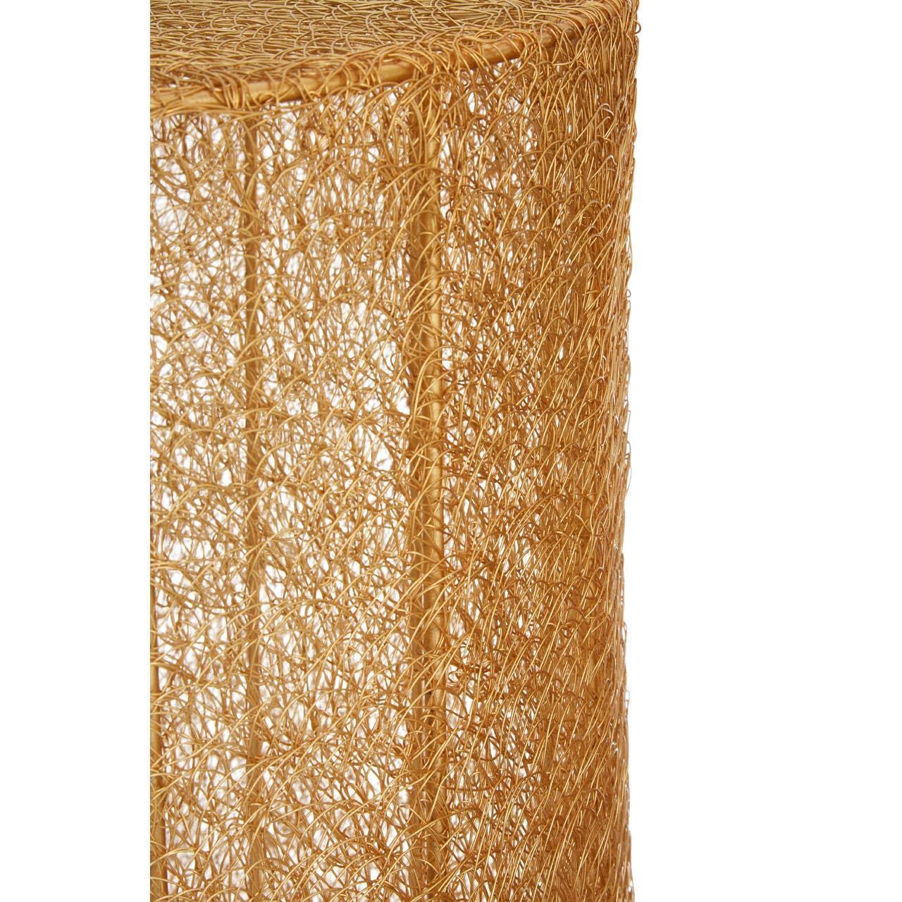 Closeup of gold metal wire side table with intricate mesh design