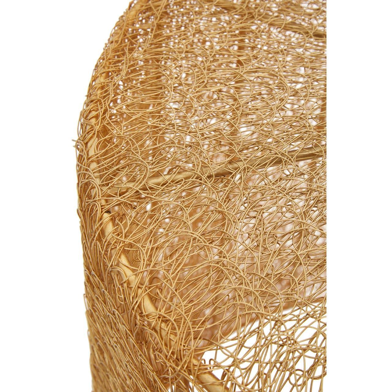 Closeup of gold wire detail on modern metal side table with textured finish