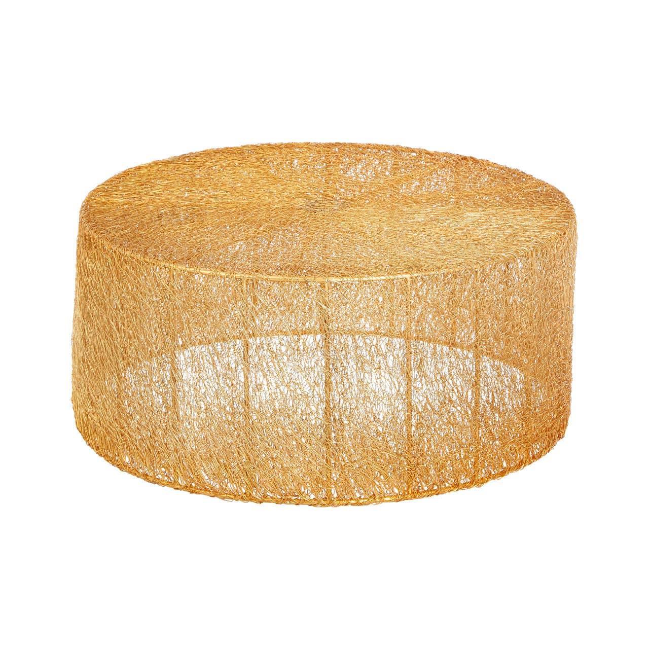Round gold wire coffee table with open weave design on white background