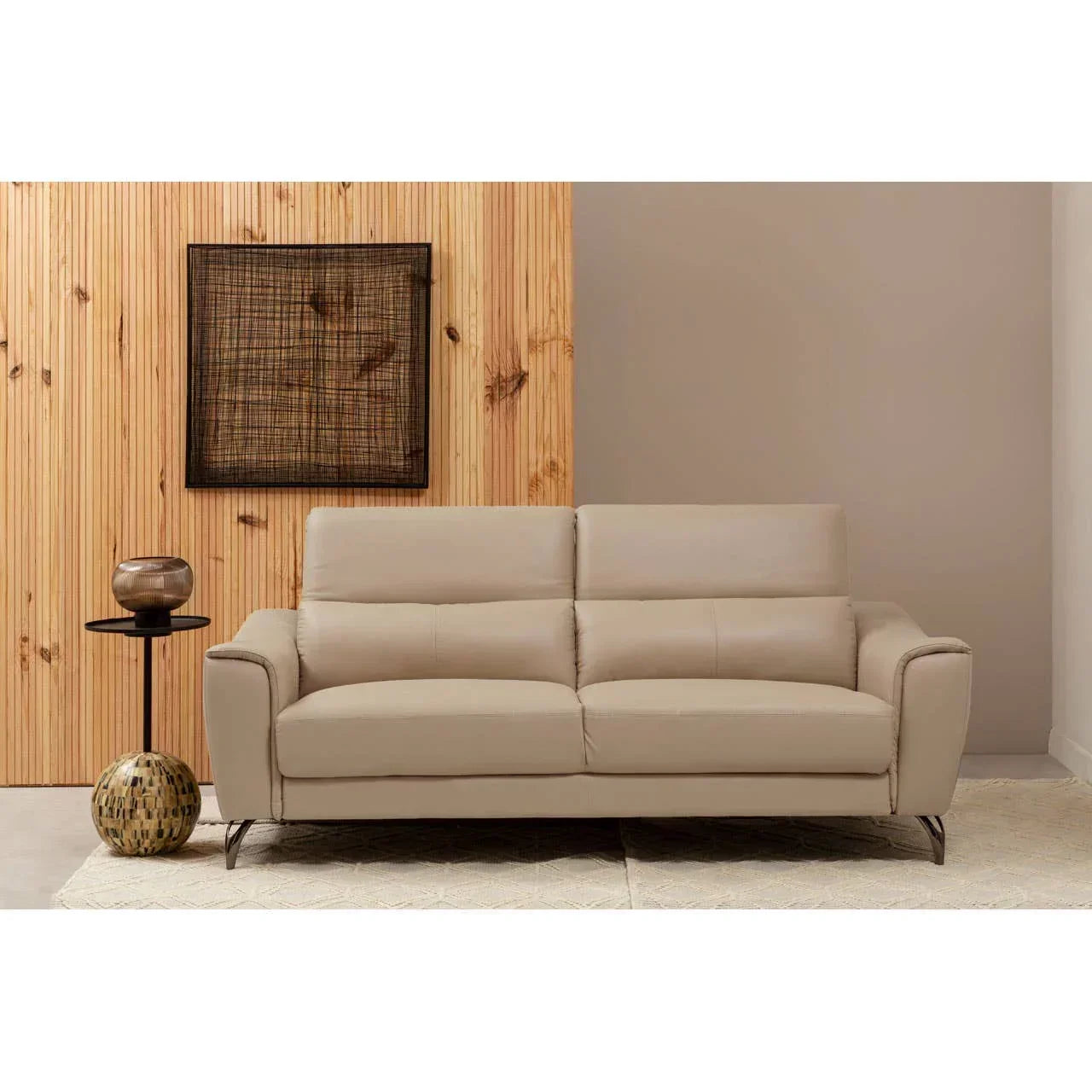 Beige leather sofa with metal legs in modern living room, wooden panel wall, side table