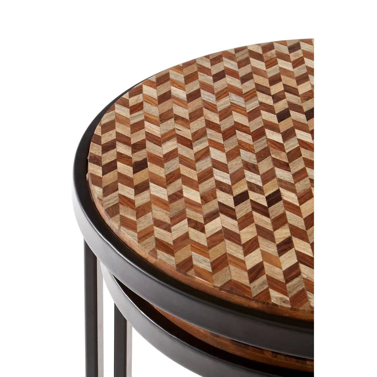 Round wooden side table with chevron pattern top and black metal frame, close-up view