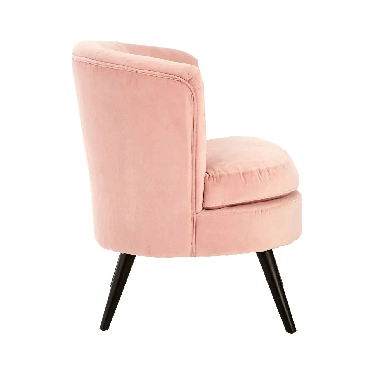 Side view of pink velvet accent chair with black angled legs