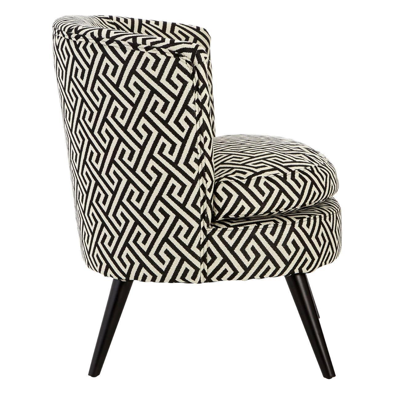 Accent chair with black and white geometric upholstery and tapered black legs side view