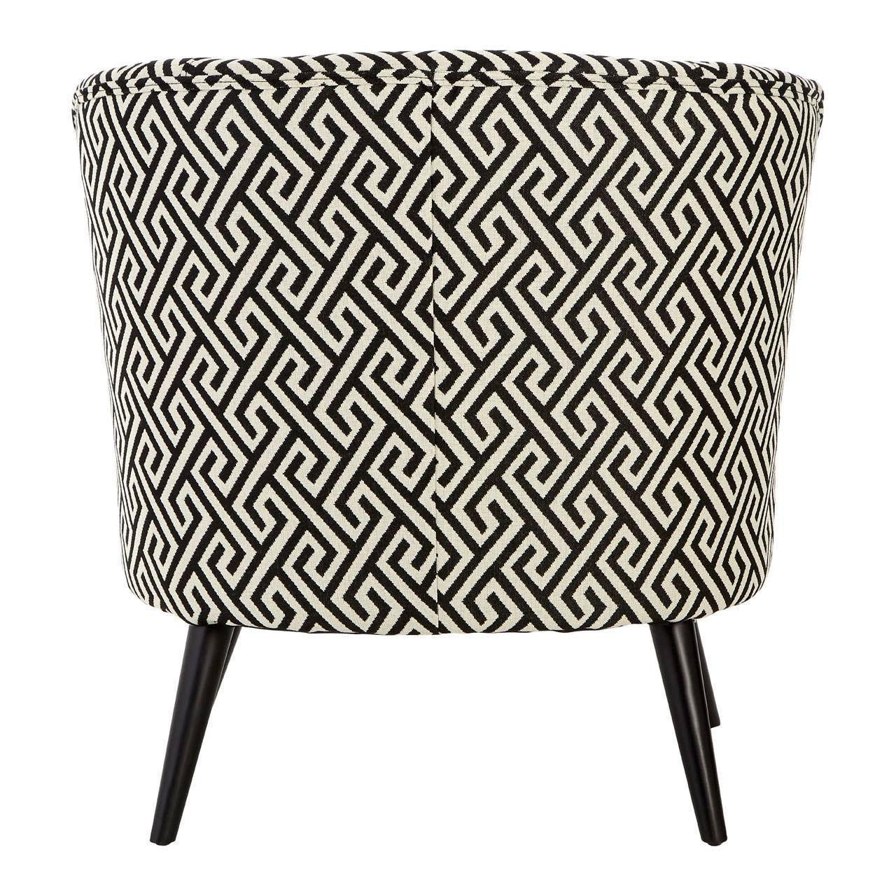 accent chair with black and white geometric upholstery and tapered black legs, rear view