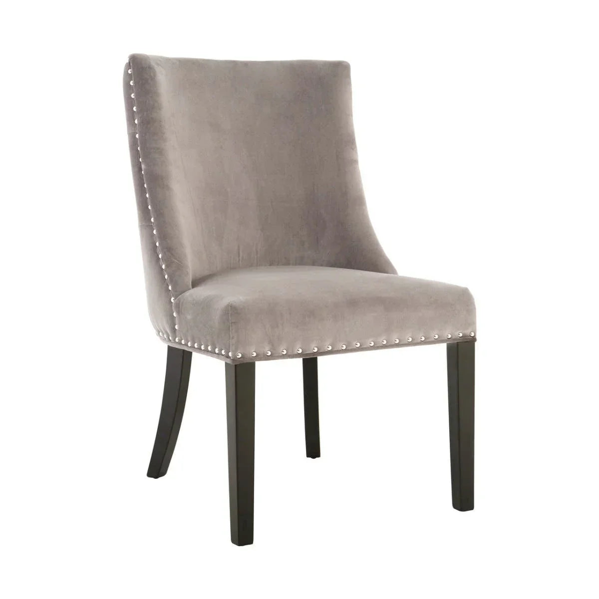 Grey velvet dining chair with silver stud trim and black wooden legs, side angle view