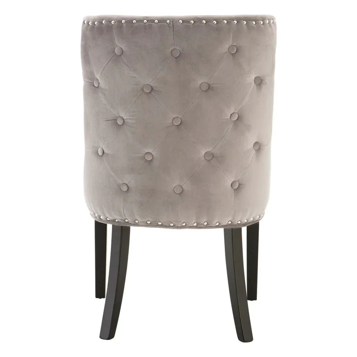 Grey velvet dining chair with button-tufted back and stud detailing, black wooden legs