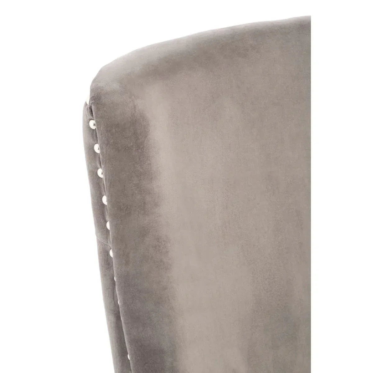 Close-up of grey velvet dining chair backrest with silver button trim