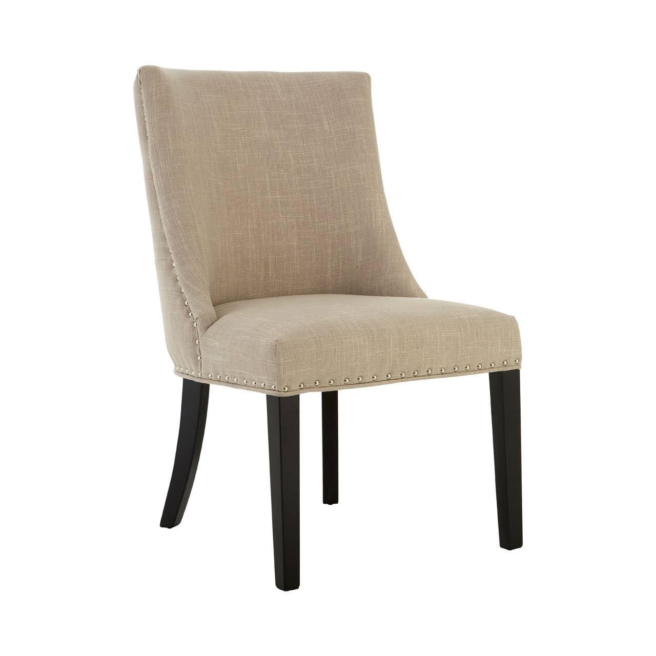 Beige upholstered dining chair with stud detailing and dark wooden legs