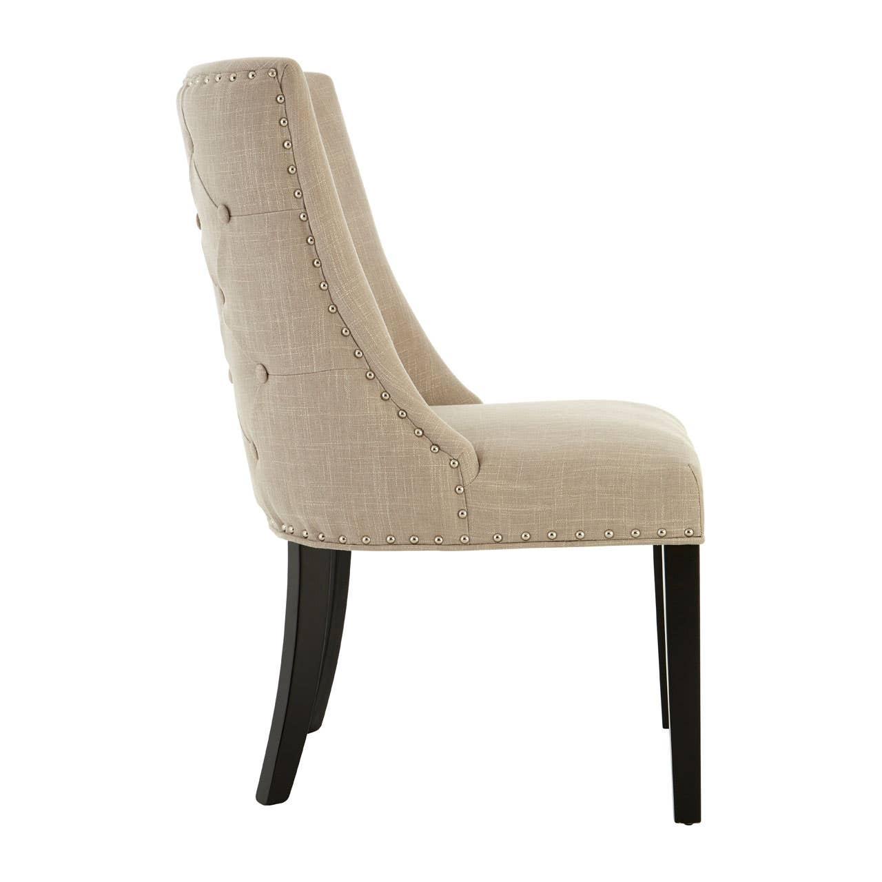 Side view of upholstered dining chair with beige fabric and black wooden legs