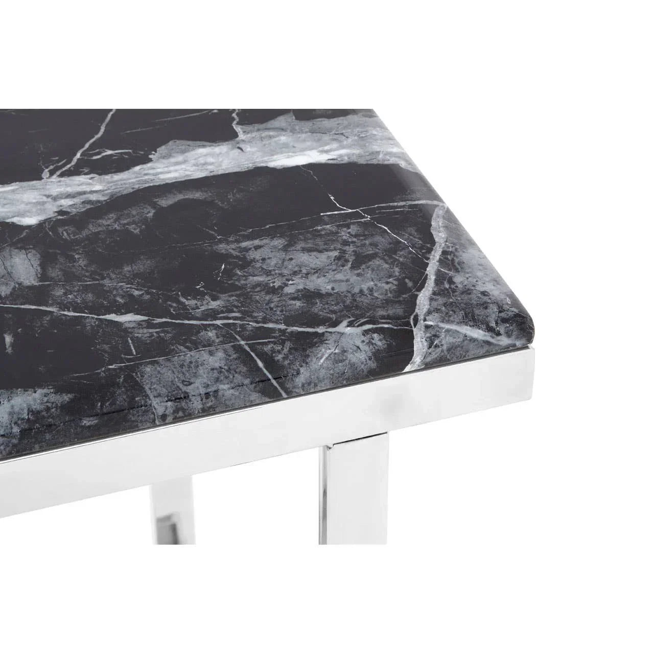 Black marble dining table corner with polished chrome legs and white veining detail