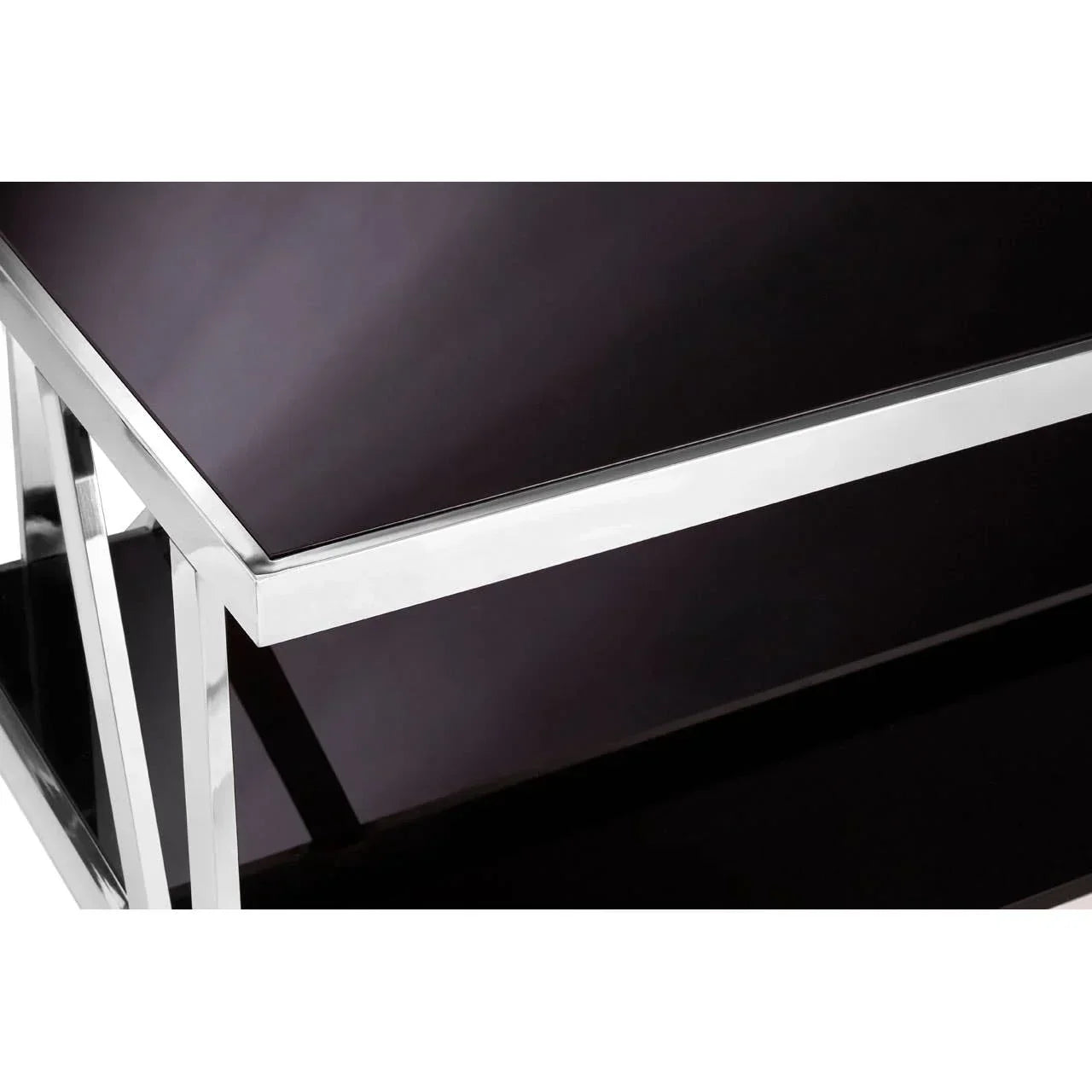 Chrome and black glass coffee table corner with geometric metal frame detail