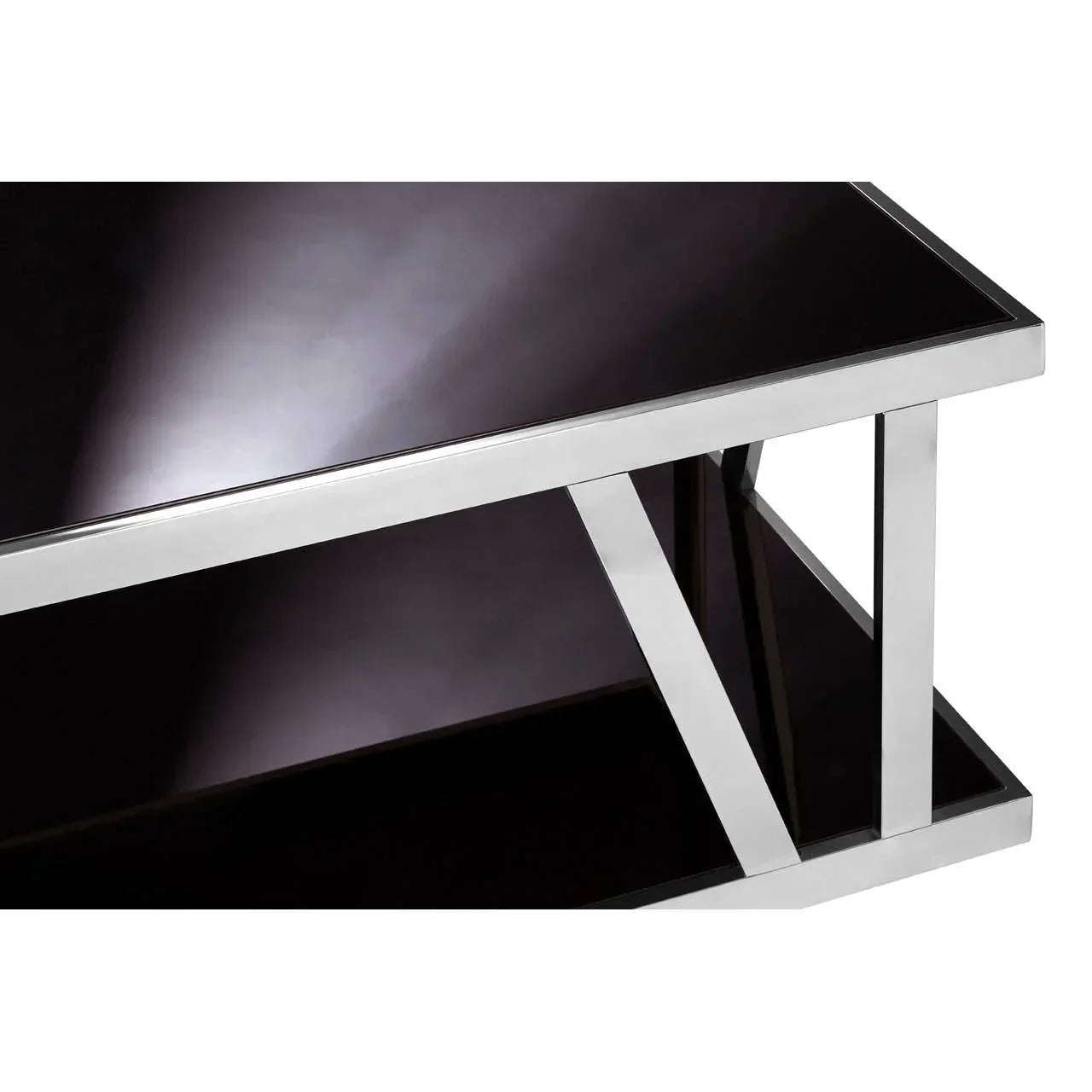 Black glass coffee table with chrome frame and lower shelf, close-up of corner detail