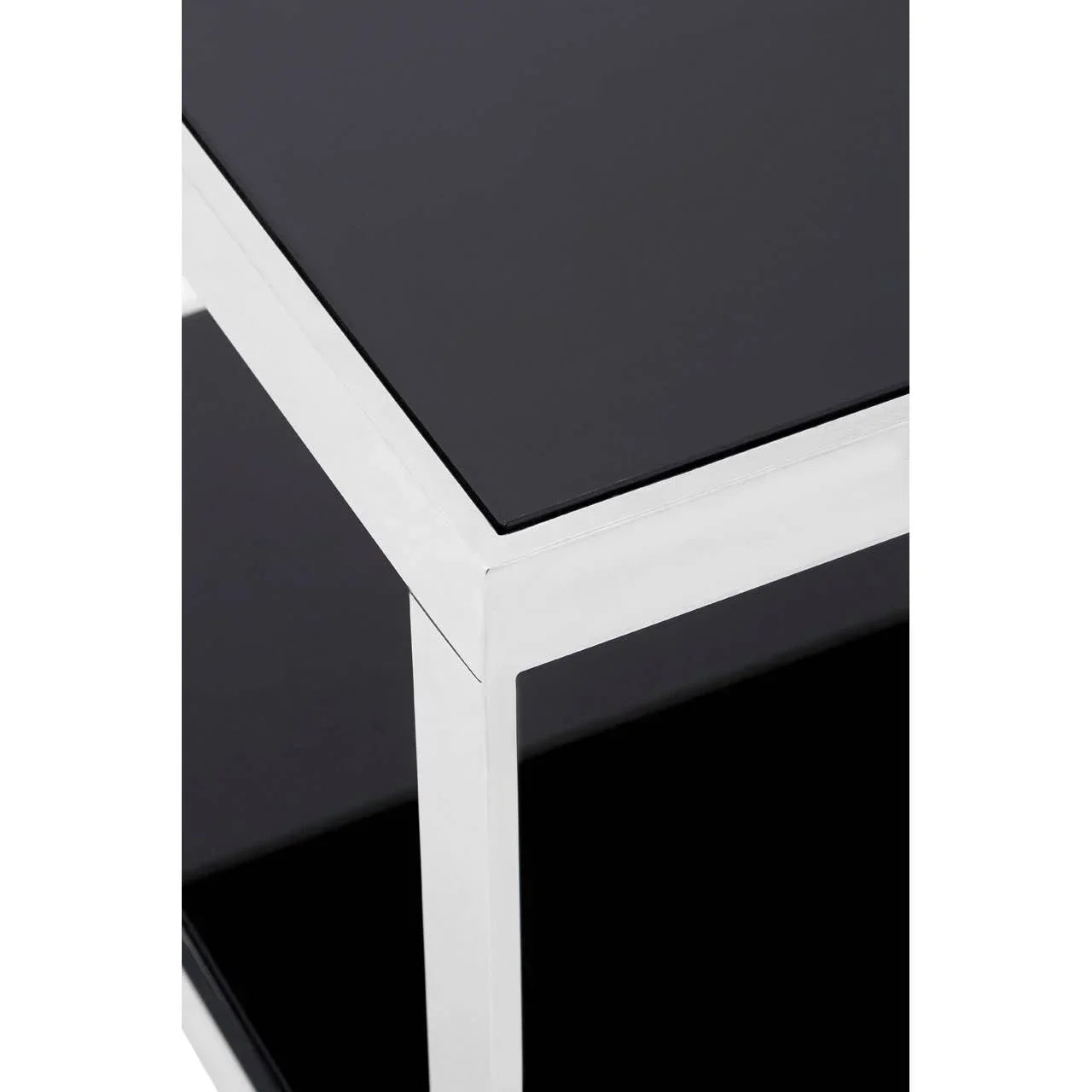 Black glass top side table with chrome metal frame, close-up corner detail