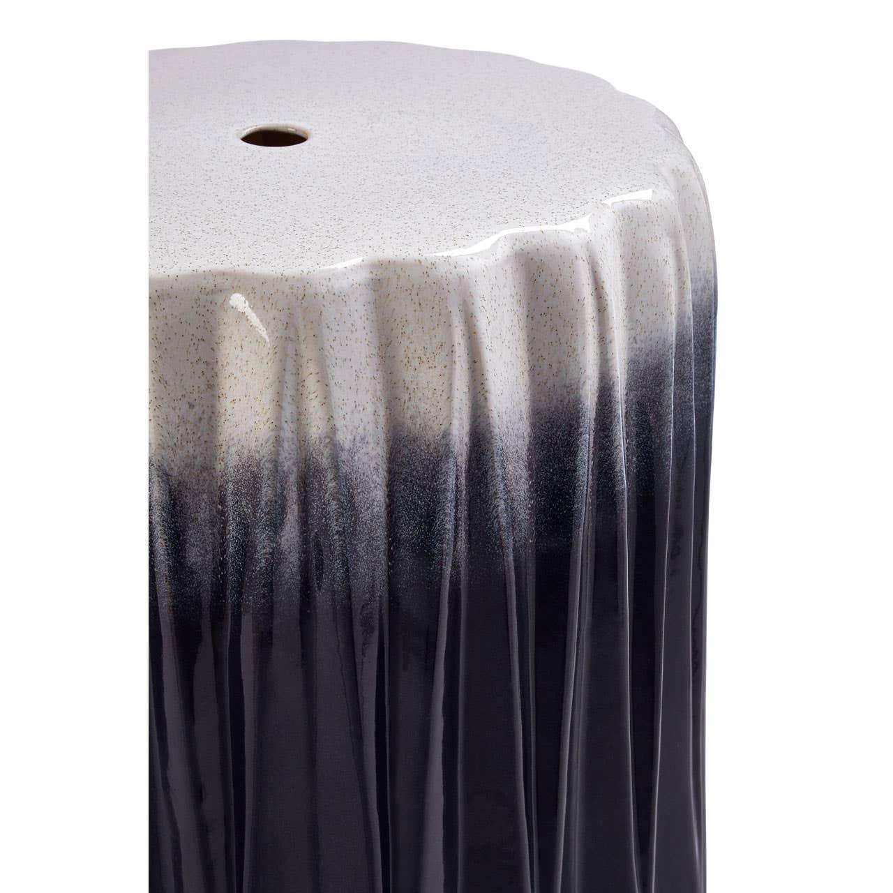 Black and white ceramic side table with textured finish and rounded top